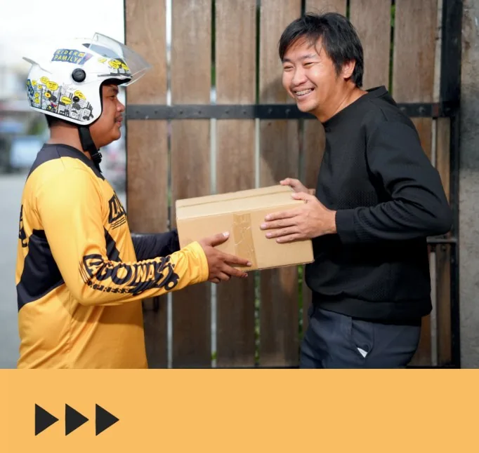LaGOna rider and a customer both smiling as a box changes hands at the gate